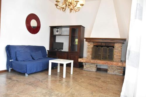 - un salon avec un canapé bleu et une cheminée dans l'établissement Casa margot, à Riva Ligure