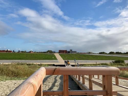 a wooden bridge over a body of water at Apartment CAPTAIN'S LODGE in Norddeich