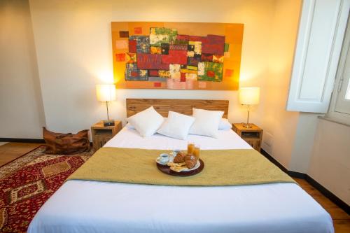 a bedroom with a bed with a plate of food on it at Torre Scribanti in Sestri Levante