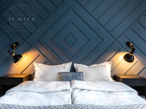 a bed with white sheets and pillows in a room at Fragola Apartments Rajska 3 - modern studios, park in Kraków