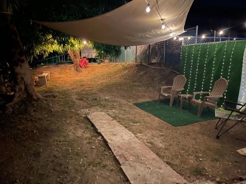 two chairs and a table under a tent at night at “Lucor D-Eight House” New Entire Home in the Town… in Rincon