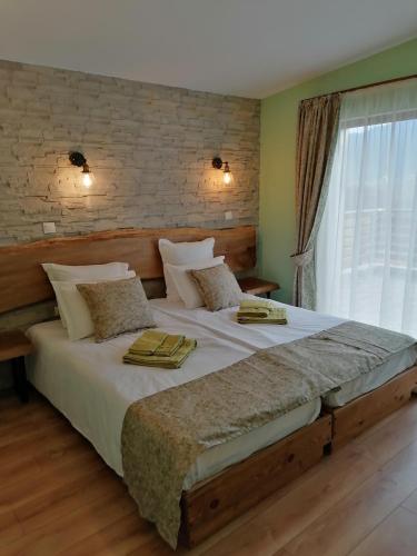 a large bed in a room with a window at Къща за гости Радост Guest House Radost in Razlog