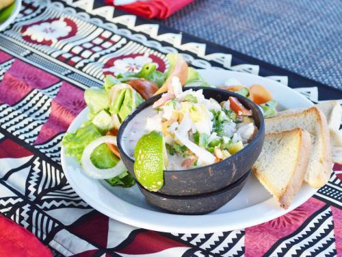 a plate of food with a bowl of salad and toast at Mantaray Island Resort in Nanuya Balavu Island