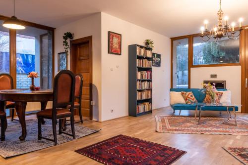 a living room with a table and a couch at Laid Back Villa in Budapest