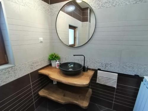 a bathroom with a sink and a mirror at Къща за гости Радост Guest House Radost in Razlog