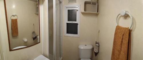 a bathroom with a toilet and a sink and a mirror at Lodge Rabasquinha in Fronteira