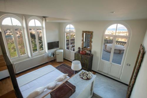 a bedroom with a bed and a room with windows at Torre Scribanti in Sestri Levante