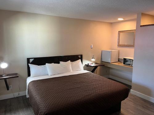 une chambre d'hôtel avec un lit et un four micro-ondes dans l'établissement Heidi's Inn, à Ilwaco