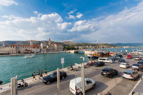 a group of cars parked in a parking lot next to the water at Vila Liza in Trogir