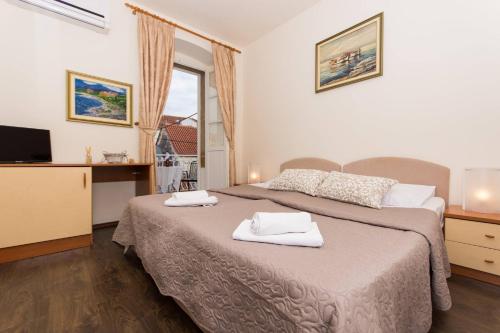 a bedroom with two beds with towels on them at Vila Liza in Trogir