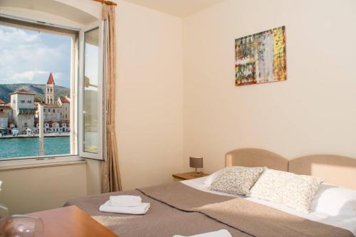 a bedroom with a bed and a window at Vila Liza in Trogir
