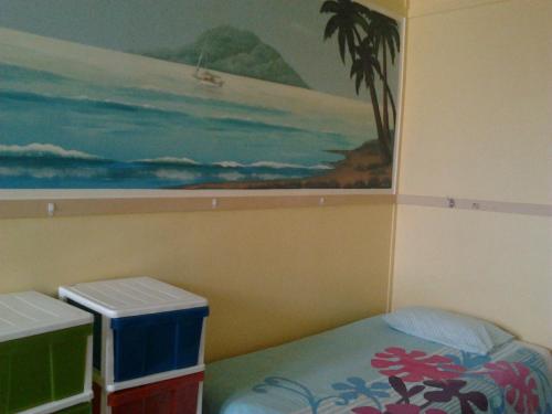 a painting of a bed and a painting of a wall at Gecko's Rest Budget Accommodation & Backpackers in Mackay