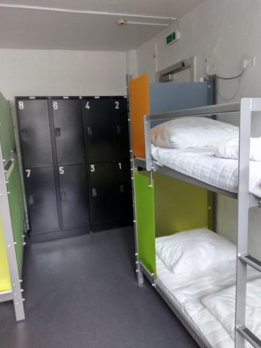 a room with two bunk beds and black cabinets at Sleep in Heaven in Copenhagen