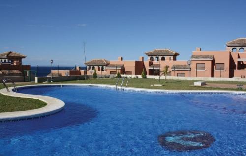 a large blue swimming pool in front of a building at Amazing Mountain and Sea Views - Mojon Hills, Isla Plana, Spain in Isla Plana