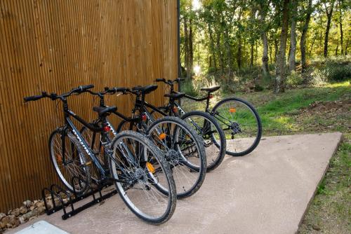 three bikes are parked next to a wall at Cabanas Mirador Cachamuíña in Ourense