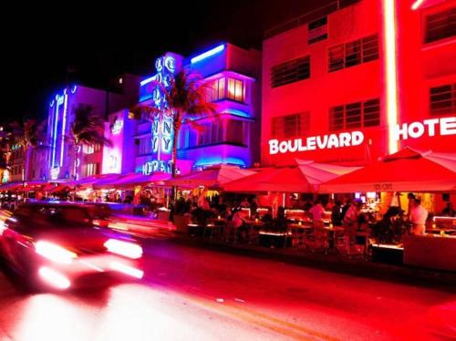 a car driving down a city street at night at Stunning Little Havana Suites Close to airport, Calle Ocho, Brickell, Wynwood and the Beaches - Free Parking in Miami