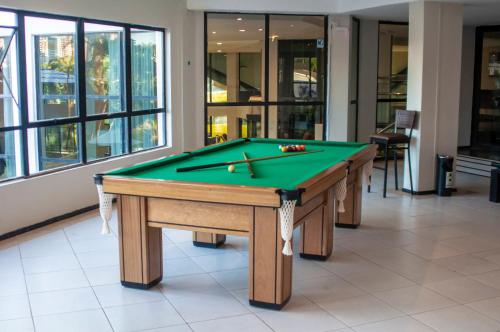 a billiard table in a room with afits at Hotel Portinari Centro in Foz do Iguaçu