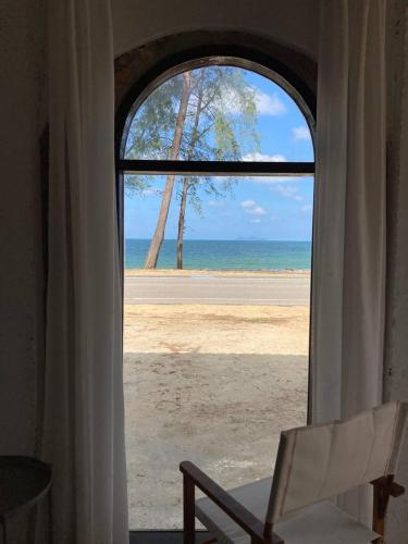 an open window with a view of the beach at Tamu Beradu Seaview Private Pool Villa in Dungun