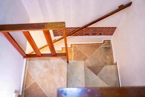 a staircase in a house with a wooden railing at Acoara Beco Doce in Jericoacoara
