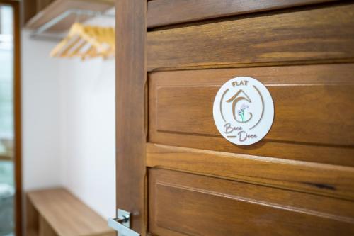 a wooden door with a sign that says air dry cleaners at Acoara Beco Doce in Jericoacoara