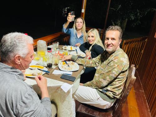 a group of people sitting at a table eating food at Sunrise of Tambopata in Puerto Maldonado
