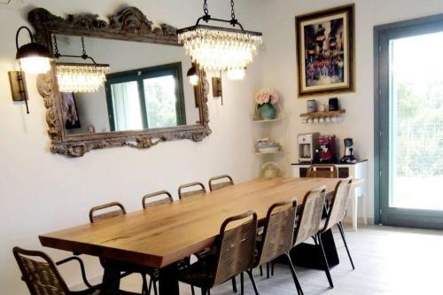 a dining room table with chairs and a mirror at Villa Celeste in Rena Majore