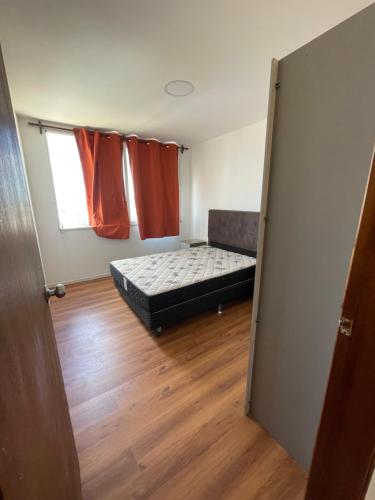 a small room with a bed and a window at Edificio Flores in Piriápolis