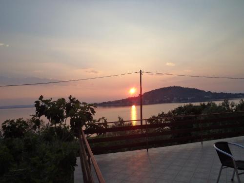 a view of a sunset over the water with a fence at Apartment Ana in Kali