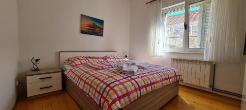 a bedroom with a bed and a window at Apartment Turan in Jelsa
