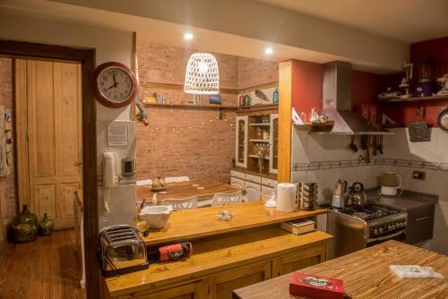 a kitchen with a counter and a clock on the wall at La Casa de Bulnes in Buenos Aires