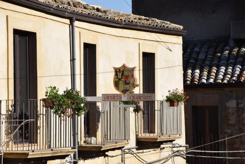 a building with potted plants on the balconies at Antichi Quartieri in Piazza Armerina