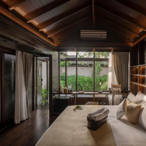 a bedroom with a large bed with a large window at The Spa Resorts - Lamai Beach in Lamai