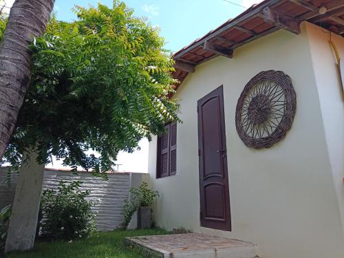 a door to a house with a wreath on it at Arco Mundial Taíba in Taíba