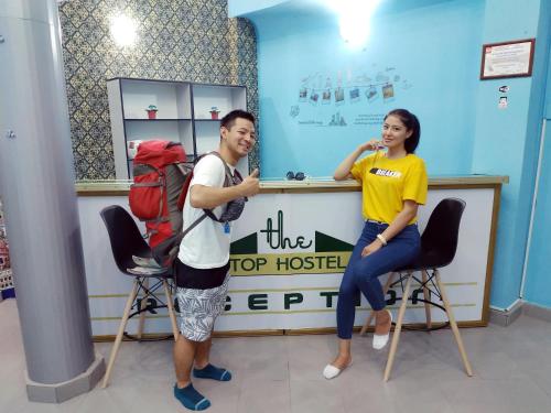 a man and a woman sitting at a top hostel at The Top Hostel in Tashkent
