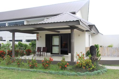 a white house with a metal roof at Lander's Bay Resort in Lautoka