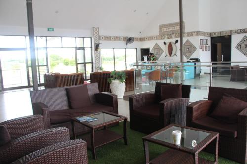 a waiting room with chairs and tables and a lobby at Lander's Bay Resort in Lautoka