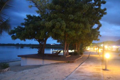 a park bench next to a river at night at Lander's Bay Resort in Lautoka