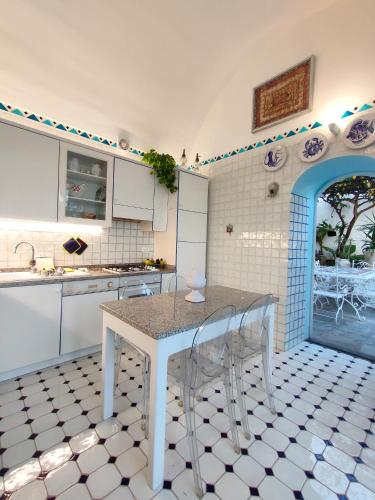 a kitchen with a table and chairs in a room at Villa Marunnella in Praiano