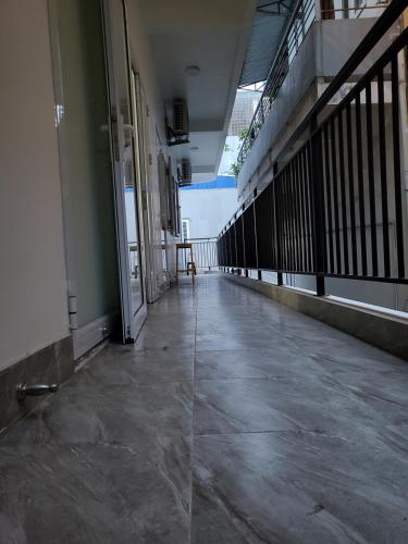 an empty hallway of a building with an open door at BA CON ECH Home and Stay- No 28 lane 259 Nguyen Duc Canh in Hai Phong