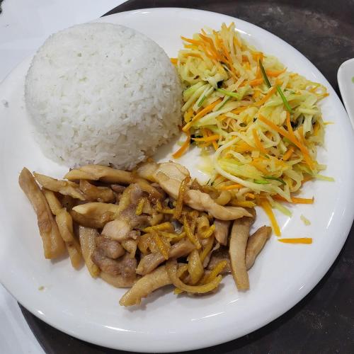 a white plate of food with rice and vegetables at BA CON ECH Home and Stay- No 28 lane 259 Nguyen Duc Canh in Hai Phong