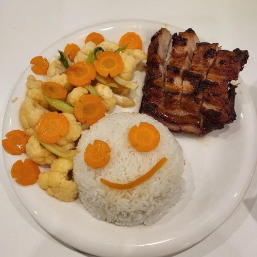 a plate of food with rice and meat and vegetables at BA CON ECH Home and Stay- No 28 lane 259 Nguyen Duc Canh in Hai Phong