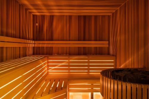 a wooden sauna with a tub in the middle at Apartmán na statku in Náměšť nad Oslavou