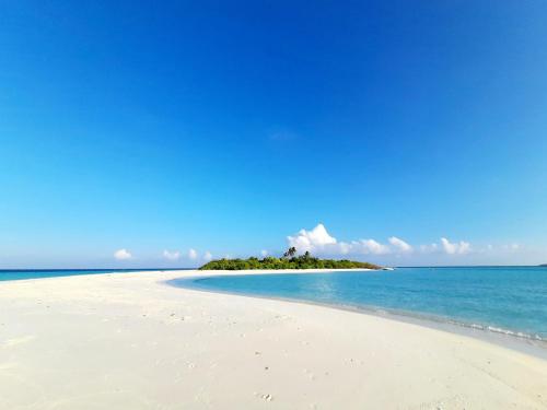 a small island in the ocean on a beach at Island Grand Maldives in Hangnaameedhoo