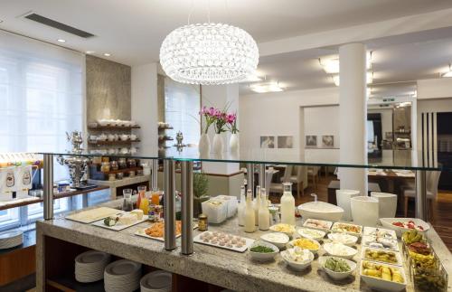 a buffet table with plates of food on it at Boutique Hotel Das Tigra in Vienna