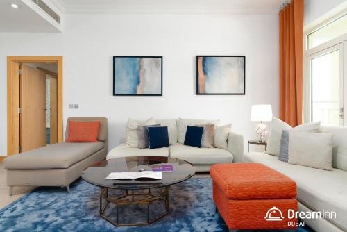a living room with a couch and a table at Dream Inn - Shoreline Palm Jumeirah in Dubai