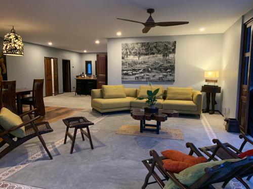 a living room with a couch and a table at I love phants Lodge in Ban Huai Thawai