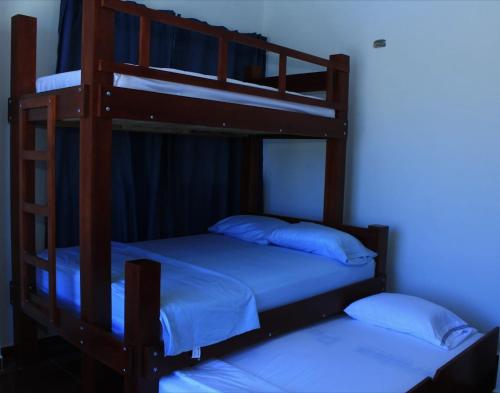 two bunk beds in a room with a blue light at Cabaña Villas de Santa Veronica in Juan de Acosta