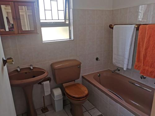 a bathroom with a toilet and a sink and a tub at No. 3 Crow's nest in Margate