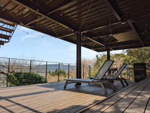 a patio with a bench on a wooden deck at VILLA HAKONE湖空 in Hakone