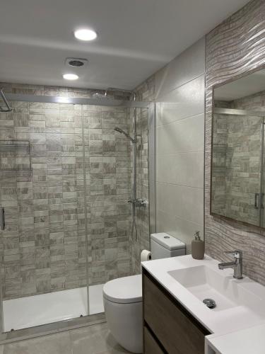 a bathroom with a toilet and a sink and a shower at Fuengirola Center in Fuengirola